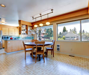 light brown tile flooring in kitchen with table and chairs