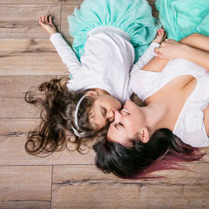 brown laminate wood-look flooring with mother and daughter lying down